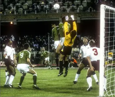  ??  ?? Paul McGrath and Niall Quinn apply pressure on England goalkeeper Peter Shilton from a setpiece during th the 1990 World Cup finals in Cagliari, Ireland’s first-ever game at that level.