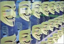  ?? [SETH WENING/THE ASSOCIATED PRESS] ?? Masks worn by members of the global hacking group Anonymous