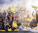  ?? ROBERTO E. ROSALES/JOURNAL ?? New Mexico United fans wildly cheer for their favorite team before the squad’s inaugural game March 9 at Isotopes Park.