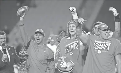  ?? PATRICK BREEN/REPUBLIC ?? Clemson coach Dabo Swinney and quarterbac­k Trevor Lawrence celebrate their win over Ohio State in the Fiesta Bowl College Football Playoff semifinal game at State Farm Stadium in Glendale.