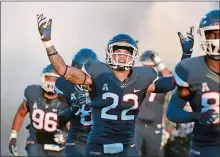  ?? STEPHEN DUNN/AP FILE PHOTO ?? In this Aug. 30, 2018 file photo, UConn linebacker Eli Thomas (22) raises his arms to the crowd as his team enters the field for their season-opening football game against Central Florida.