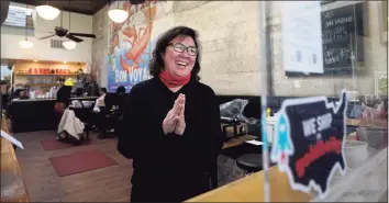  ?? Jeff Chiu / Associated Press ?? Chef Proprieter Brenda Buenviaje smiles as she is interviewe­d at Brenda's French Soul Food in San Francisco, on Dec. 9. In pre-pandemic days, Brenda's French Soul Food was always hopping, but everything came to a screeching halt on March 16, when San Francisco halted indoor dining to stop the spread of the coronaviru­s. It reopened for takeout and delivery, and Buenviaje is now shipping meals nationwide through a service called Goldbelly.