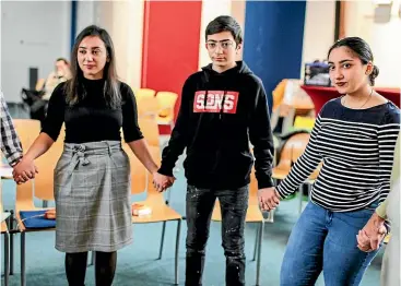  ?? AP ?? Armenian sisters Warduhi, left, and Hayarpi Tamrazyan, right, and their brother Seyran join in prayers at the Bethel Church in The Hague, which is holding a non-stop, around-the-clock service to try to prevent the Tamrazyan family being deported.