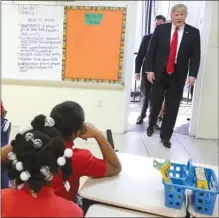  ?? The Associated Press ?? U.S. President Donald Trump pays a visit to a classroom at St. Andrew Catholic School in Orlando, Fla., on Friday.