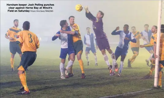  ?? Picture: Chris Davey FM4622465 ?? Horsham keeper Josh Pelling punches clear against Herne Bay at Winch’s Field on Saturday