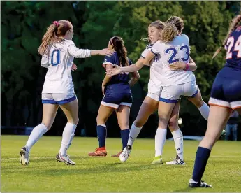  ?? Photo courtesy of Emma Leininger/JBU Sports Informatio­n ?? John Brown University women’s soccer players, from left, Sienna Carballo, Ryan Winingham and Megan Hutto celebrate after Winingham scored in the 89th minute to break a 3-3 tie and give the Golden Eagles a 4-3 victory over Baker (Kan.) on Thursday in the NAIA National Tournament Opening Round semifinal at Alumni Field.