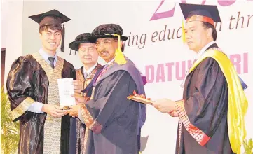  ??  ?? Musa (second right) presenting the Top Achiever Award for School of Business to Stefan Bradley Alex while Wong (second left) and Defrey Ubin look on.