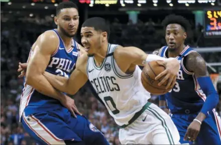  ?? ELISE AMENDOLA — THE ASSOCIATED PRESS ?? Celtics forward Jayson Tatum (0) drives against 76ers guard Ben Simmons, left, and forward Robert Covington, right, during the second half of Game 2of an the Eastern Conference semifinals Thursday in Boston. The Celtics won 108-103.