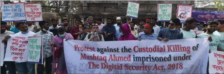  ?? — AFP photo ?? Activists hold placards demanding the repeal of the Digital Security Act, in Dhaka following the death of Ahmed in jail months after his arrest under internet laws which critics say are used to muzzle dissent.