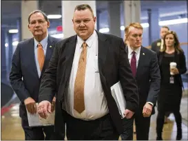  ?? AP ?? Sen. Jon Tester, D-Mont., flanked by Sen. John Boozman, R-Ark. (left) and Sen. James Lankford, R-Okla., arrive with other lawmakers for a procedural vote Tuesday.