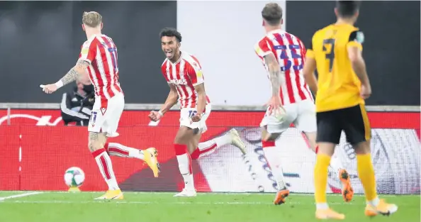  ??  ?? WHAT A FEELING: Jacob Brown celebrates scoring the winner in last night’s Carabao Cup win at Premier League Wolves. Below, Stoke survive a scare.
PA Photo.