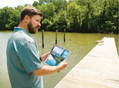  ?? LLOYD FOX/BALTIMORE SUN ?? Edgewater resident Peter Turcik recently had one of his photos of Mallows Bay — an alcove in the Potomac River known for its array of sunken “ghost ships”— turned into a U.S. postage stamp as part of a series depicting National Marine Sanctuarie­s across the country.