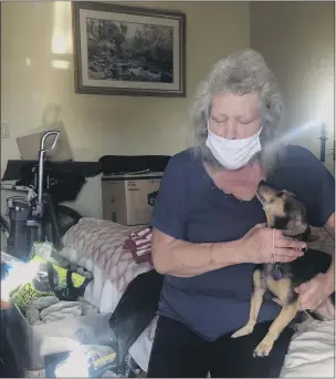  ?? NATALIE HANSON — ENTERPRISE-RECORD ?? Mary McCullough, 64, seen Tuesday, has been staying in her room at an inn in Chico with her dog Christie since March. A Camp Fire survivor, Mary said since becoming homeless in Oroville she has been grateful for help from Safe Space Winter Shelter through Project Roomkey to stay sheltered in the inn during the COVID-19pandemic and to get help finding a permanent living situation.