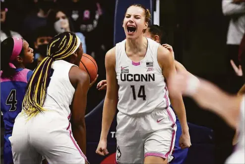  ?? Jessica Hill / Associated Press ?? UConn’s Dorka Juhász (14) reacts with Aaliyah Edwards after making a basket during a game last season against DePaul.