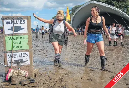  ??  ?? Music fans had to watch their step in wellies as the heavens opened creating a sea of mud for festival-goers