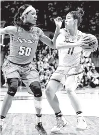  ?? THE ASSOCIATED PRESS ?? Connecticu­t’s Kia Nurse keeps the ball from Syracuse’s Briana Day, left, during their second-round game in the NCAA tournament Monday in Storrs, Conn. Nurse scored 29 points.