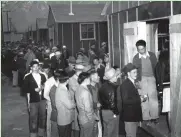  ?? ASSOCIATED PRESS ?? Japanese citizens wait for home assignment­s at an internment camp in Manzanar, Calif.