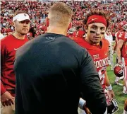  ?? [PHOTO BY BRYAN TERRY, THE OKLAHOMAN] ?? Texas Tech coach Kliff Kingsbury, center, and Oklahoma quarterbac­k Baker Mayfield shake hands after last season’s game in Lubbock. Has the thaw in Kingsbury-Mayfield relations continued? Big 12 Media Days will give us an indication.
