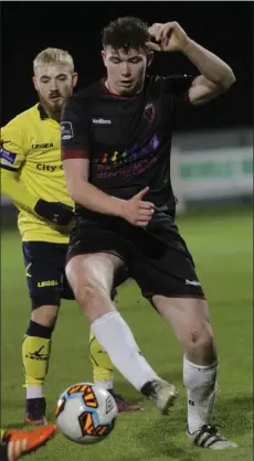  ??  ?? Craig Hayes keeps the ball away from Dylan McGlade of Longford.