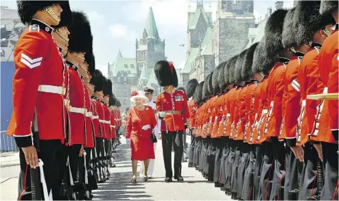  ?? JOHN STILLWELL / GETTY IMAGES ?? Queen Elizabeth II inspects a Guard of Honour on Parliament Hill in Ottawa in 2010. Having a monarchy has enabled Canadians to preserve what would once have been thought of as republican virtues, Colby Cosh writes.