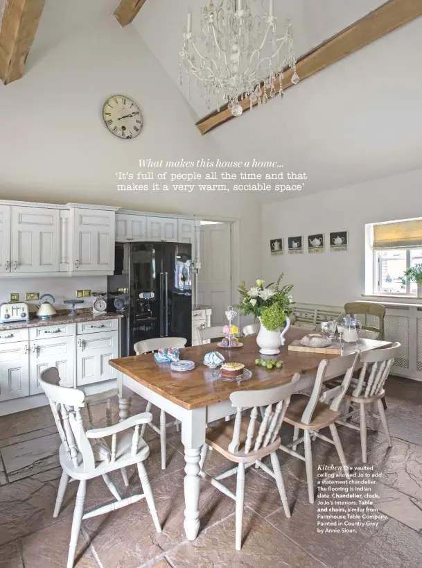  ??  ?? Kitchen The vaulted ceiling allowed Jo to add a statement chandelier.
The flooring is Indian slate. Chandelier, clock, Jojoõs Interiors. Table and chairs, similar from Farmhouse Table Company. Painted in Country Grey by Annie Sloan.