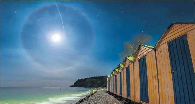  ??  ?? Ring oflight This rare moon halo was spotted over Shanklin beach on the Isle of Wight. The halo forms when light from a full moon is refracted through ice crystals in high cirrus clouds. It is known as a 22-degree halo and is more commonly seen around the sun.
