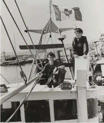  ??  ?? To mark their support for the Canadian fishermen, some Dingle fishing boats flew the Canadian flag on Thursday and Friday; in the picture are Patrick Russell (12) and Damien O’Neill (12).