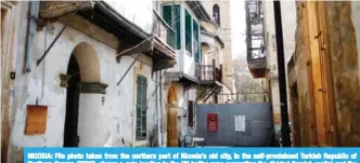  ??  ?? NICOSIA: File photo taken from the northern part of Nicosia’s old city, in the self-proclaimed Turkish Republic of Northern Cyprus (TRNC), shows a gate leading to the UN buffer zone separating the divided Cypriot capital and the Holy Cross Catholic...