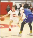  ?? Emily J. Reynolds / For Hearst Connecticu­t Media ?? Cromwell’s Nick Wright drives to the basket past Old Lyme’s Aedan Using on Monday.