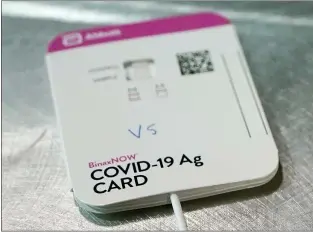  ?? TED S. WARREN — AP ?? This Wednesday, Feb. 3, 2021 file photo shows a BinaxNOW rapid COVID-19 test made by Abbott Laboratori­es, in Tacoma, Wash.