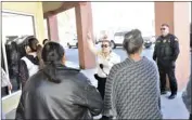  ?? MARIO RENTERIA FILE PHOTO ?? A code enforcemen­t official with the city of El Centro talks to upset residents of The Mayan Hotel.