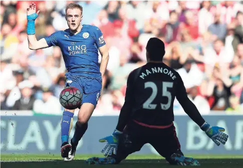  ??  ?? Leicester City’s Jamie Vardy (left) scoring past Sunderland’s goalkeeper Vito Mannone during the English Premier League match between Sunderland and Leicester City at the Stadium of Light, Sunderland, England, yesterday.