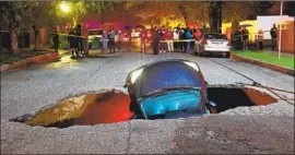  ?? Michael Owen Baker For The Times ?? A SINKHOLE that opened up near the intersecti­on of Woodbridge Street and Laurel Canyon Boulevard in Studio City swallowed two vehicles in 2017.