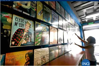  ??  ?? ANALOG TREASURES The office of lawyer Francisco Serrano in Kamuning, Quezon City, displays his vast vinyl record collection which, according to his employee Rebecca Gianan (shown here neatly arranging the albums), totals around 5,000 records.—LYN...