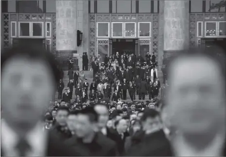  ?? Photo: AFP ?? Delegates leave the Great Hall of the People after a preparator­y meeting the day before the opening session of the 13th National People’s Congress (NPC) in Beijing on Sunday.