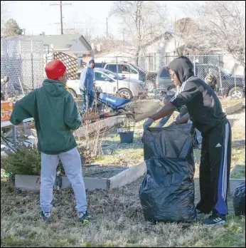  ?? PHOTO COURTESY OF MELINDA RODRIGUEZ ?? Volunteers assist Saturday in the winter preparatio­n of garden soil, raking of leaves, repair of planter boxes and more at the Elm Avenue Community Garden near downtown Lancaster. The cleanup was part of Day of Service, the first in a series of community service events dedicated to preserve the memory of Dr. Martin Luther King Jr.