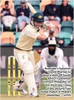  ??  ?? Australia’s batsman David Warner (L) plays a shot off South Africa’s paceman Vernon Philander on the third day’s play of the second Test cricket match in Hobart yesterday. –