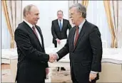  ?? ALEXEI DRUZHININ/SPUTNIK ?? Russian President Vladimir Putin greets U.S. national security adviser John Bolton on Wednesday in Moscow.