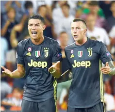  ??  ?? Ronaldo (left) reacts next to Juventus’ midfielder Federico Bernardesc­hi after receiving a red card during the UEFA Champions League group H match against Valencia at the Mestalla stadium in Valencia. — AFP photo