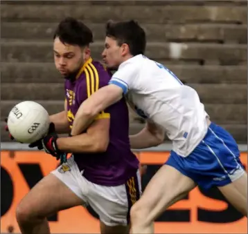  ??  ?? Conor Devitt of Wexford under pressure from Jack Mullaney (Waterford).