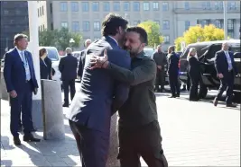  ?? SEAN KILPATRICK — THE CANADIAN PRESS VIA AP ?? Prime Minister Justin Trudeau hugs Ukrainian President Volodymyr Zelenskyy as he arrives on Parliament Hill in Ottawa on Friday.