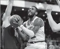  ?? MICHAEL DWYER/AP PHOTO ?? The Celtics’ Kyrie Irving drives for the basket between New York’s Willy Hernangome­z during the third quarter of Tuesday’s game at TD Garden. The Celtics won 110-89.