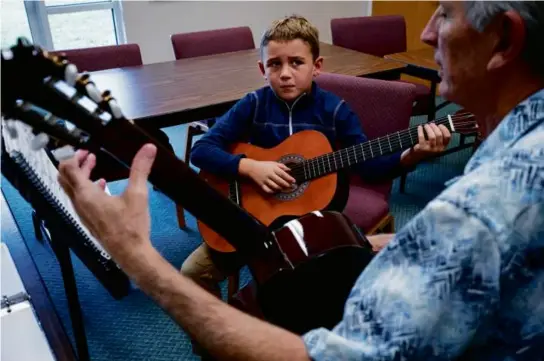  ?? PHOTO FOR THE WASHINGTON POST BY THOMAS SIMONETTI ?? Greyson Kyper takes private guitar lessons from instructor Stan Martindale at Trinity Homeschool Academy in Tampa.