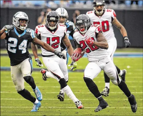  ?? JEFF SINER / TNS ?? Falcons running back Tevin Coleman takes off for a 55-yard touchdown run in the fourth quarter of Saturday’s victory over the Panthers. Coleman rushed nine times for 90 yards, and caught three passes for 45 yards.