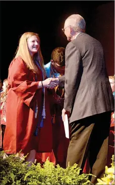  ?? Janelle Jessen/Siloam Sunday ?? Superinten­dent Ken Ramey, right, presented a $400 scholarshi­p to Malia Martin during the scholarshi­p night on Thursday. High school faculty and staff raised money to fund the scholarshi­p in honor of Ramey, who is retiring in June. Oliver Reid was the other recipient of the inaugural scholarshi­p in Ramey’s honor.