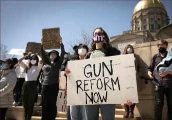  ?? Robin Rayne/ZUMA Wire/TNS ?? A woman advocating for stricter gun control laws joined hundreds from the Asian American community on March 20 outside the Georgia capitol building for rallies and a march through downtown Atalnta, protesting a surge in violence against their community.