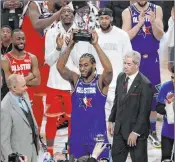  ?? David Banks The Associated Press ?? Team Lebron player Kawhi Leonard of the Clippers shows off his NBA All-star Game Kobe Bryant MVP Award after leading the winning side with 30 points.