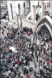  ?? NARIMAN EL-MOFTY / ASSOCIATED PRESS ?? Relatives and onlookers swarm around a car outside a church after a bomb attack in Tanta, Egypt. The attack took place on Palm Sunday, the start of the Holy Week leading up to Easter.