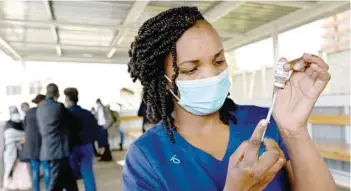  ?? — AFP ?? A health worker fills a syringe with a dose of the Astrazenec­a/oxford vaccine against Covid-19 at the Mbagathi hospital vaccinatio­n centre in Nairobi on Tuesday.