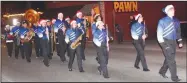  ?? Westside Eagle Observer/MIKE ECKELS ?? The Decatur High School marching band makes its appearance during the Decatur Chamber of Commerce’s annual Christmas parade through downtown Decatur Friday night. The band provided seasonal music as well as the Decatur Bulldog fight song as they traversed through the half-mile-long parade route.